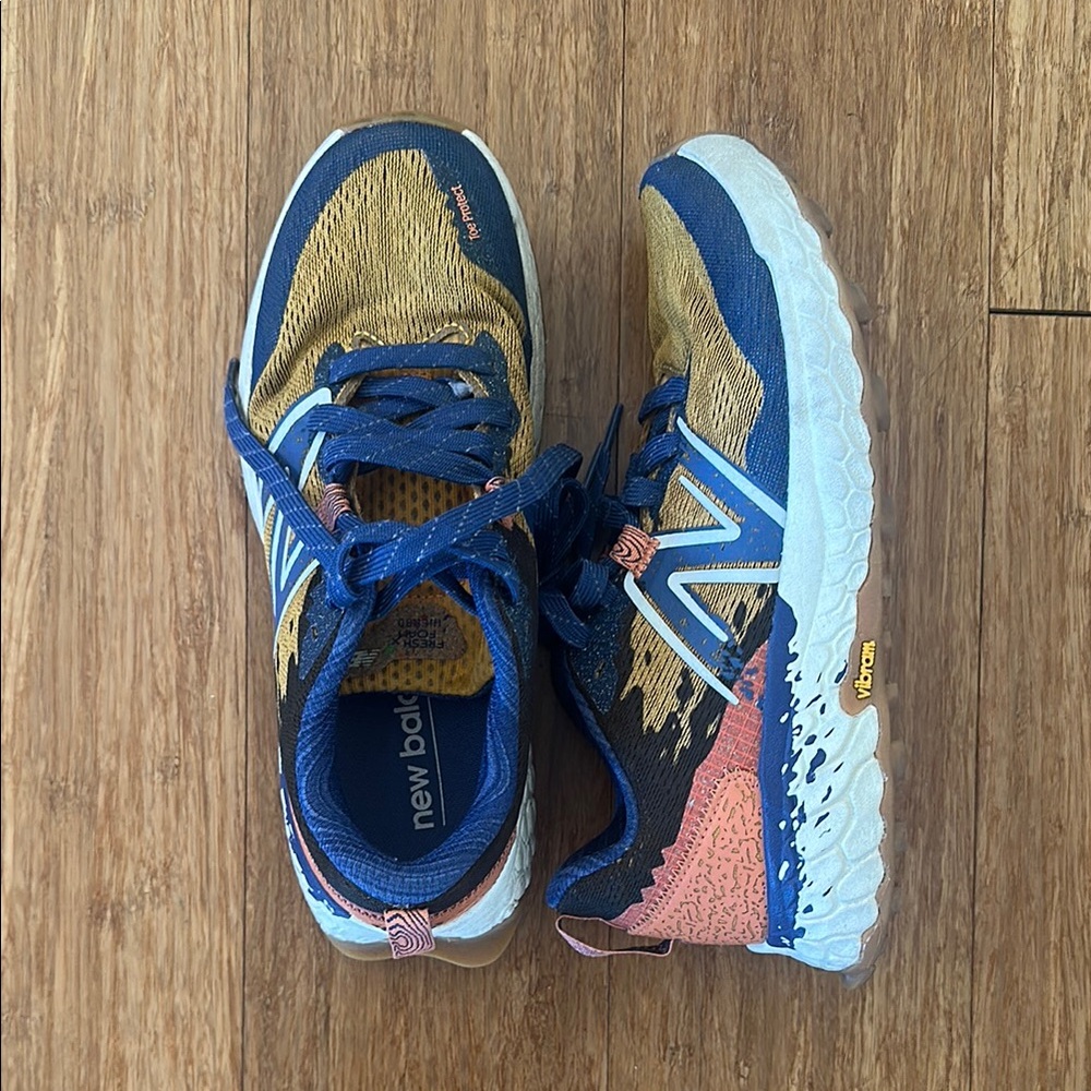 Women's 7.5 New Balance Blue and Gold Trail Shoes with Vibram soles